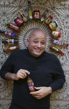 Farr with his collection of chilli sauces.