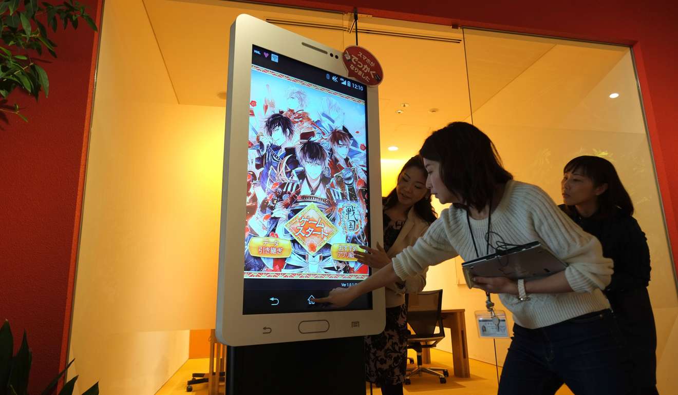 A huge game machine displaying the popular dating simulation game Ikemen. Photo: AFP