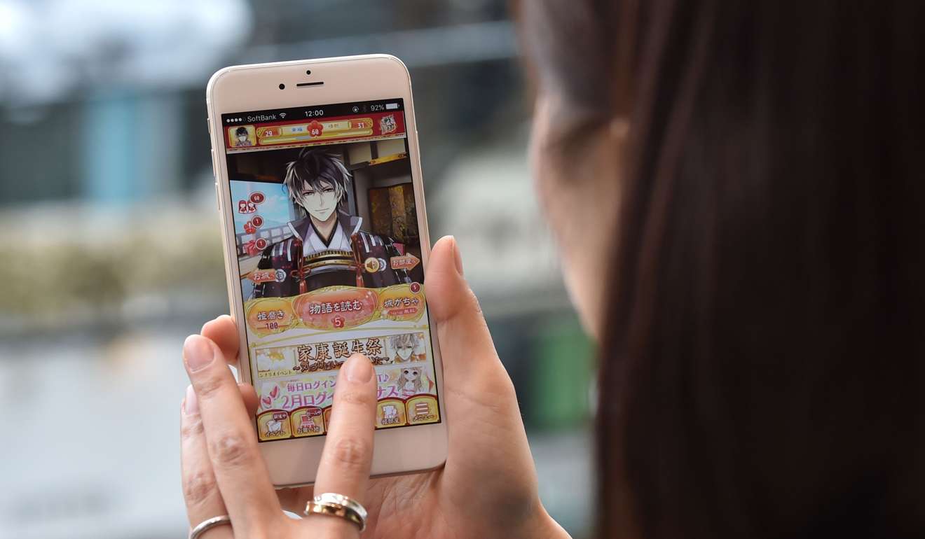 A woman playing a popular dating simulation game Ikemen. Photo: AFP