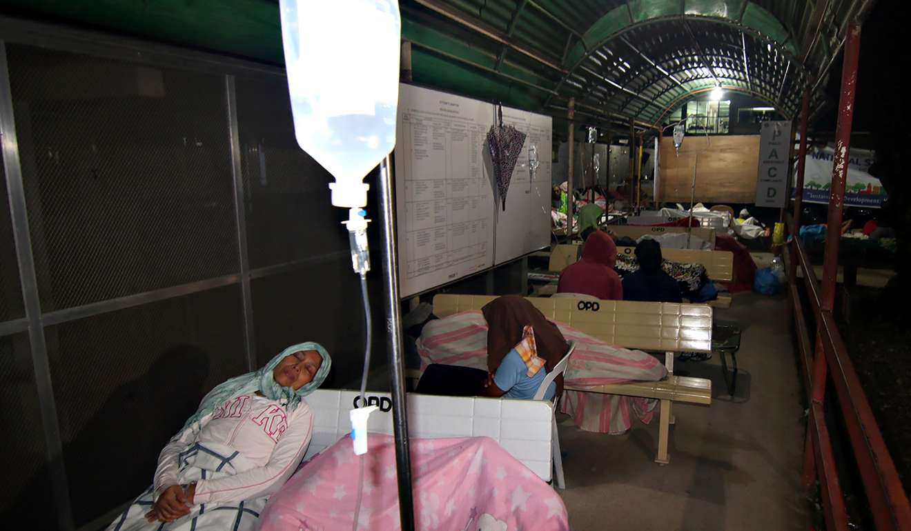 Hospital patients take shelter in a pedestrian-waiting shed after a 6 .5-magnitude earthquake struck overnight in Surigao City in the southern Philippines. Photo: AFP