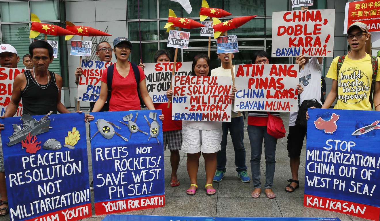 Environmental activists demonstrate with mock missiles during a rally at the Chinese Consulate in Manila on January 24. They were protesting against the alleged military build-up by China on the disputed Spratly islands in the South China Sea. Photo: AP