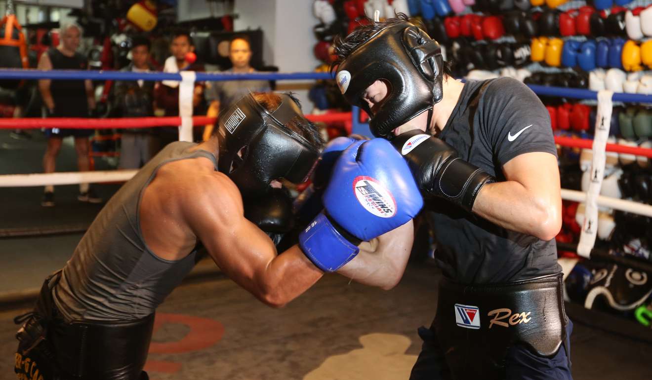 Rex Tso (right) spars with Filipino boxer Mark Anthony Geraldo at DEF Boxing gym in Sheung Wan. Photo: Xiaomei Chen