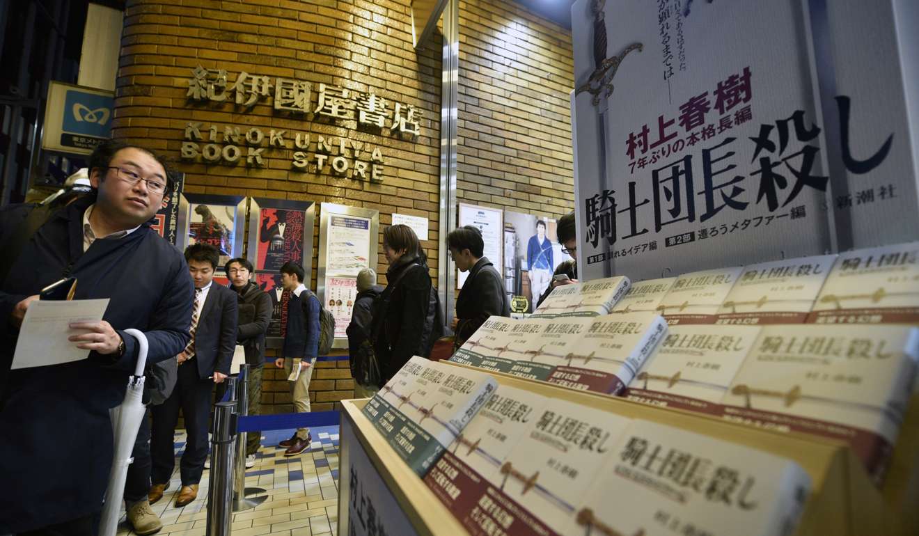 Fans of Japanese best-selling author Haruki Murakami line up next to a display of the new book 'Kishidancho Goroshi' or 'Killing Commendatore' at Kinokuniya bookstore. Photo: EPA