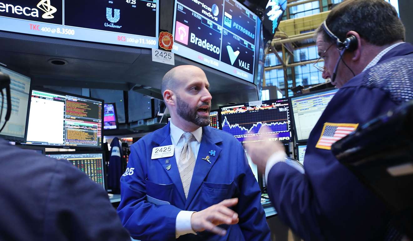 Traders work on the floor of the New York Stock Exchange (NYSE) as stocks fell on Friday. Photo: AFP