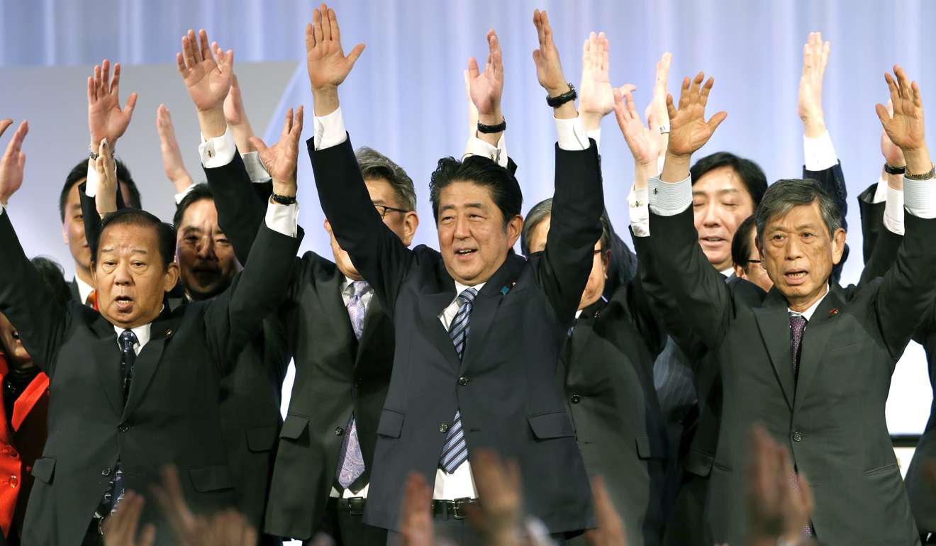 Japanese Prime Minister Shinzo Abe, centre, shouts traditional ‘Banzai (long life)’ cheers with lawmakers and members of his ruling Liberal Democratic (LDP) Party during its annual convention in Tokyo. Photo: AP