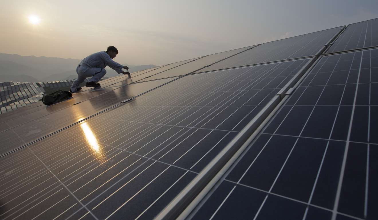 A worker performs maintenance work on solar panels in Fujian province. Power generation in China grew 6.3 per cent year on year in January and February. Photo: AP