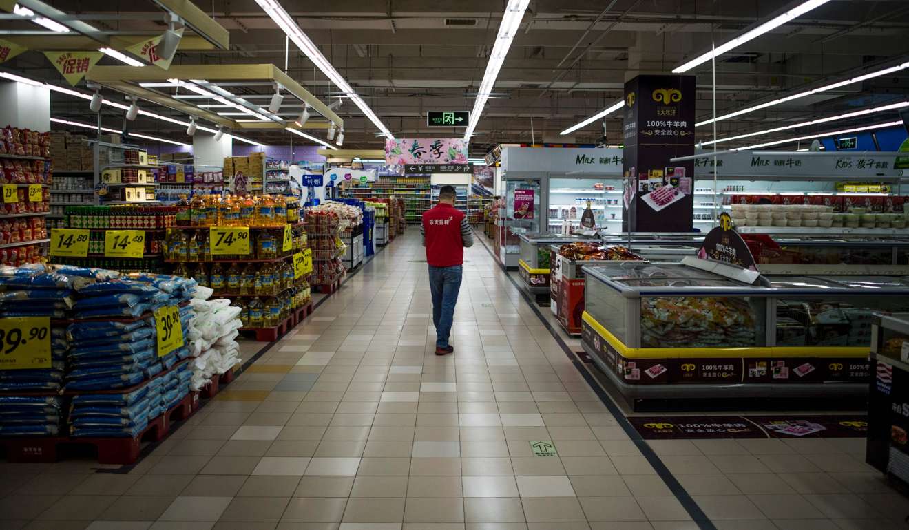 A Lotte Mart employee stands in an almost empty store on Monday in Shanghai. The store remained open but dozens of other Lotte stores in China have been closed, amid a boycott of South Korean products. Photo: AFP