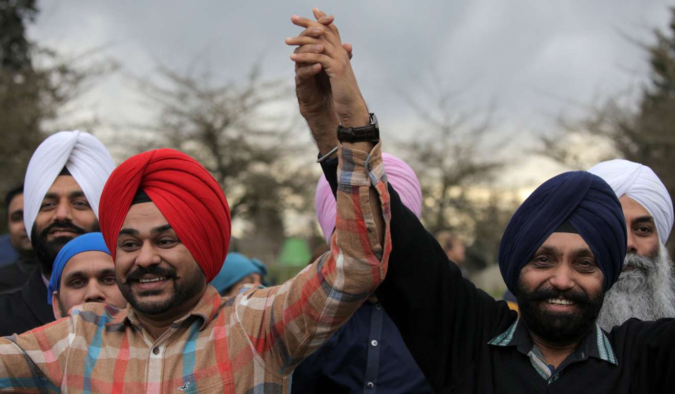 Sikh men hold hands during a vigil in honour of Srinivas Kuchibhotla, an immigrant from India who was recently shot and killed in Kansas. Photo: Reuters