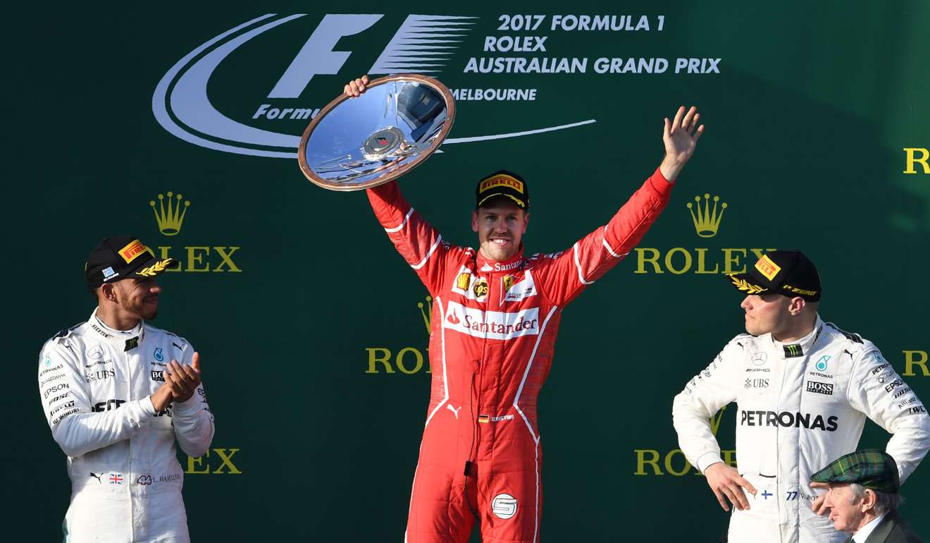 Sebastian Vettel (centre) celebrates on the podium with Mercedes' Lewis Hamilton (left) and Valtteri Bottas (right). Photo: AFP