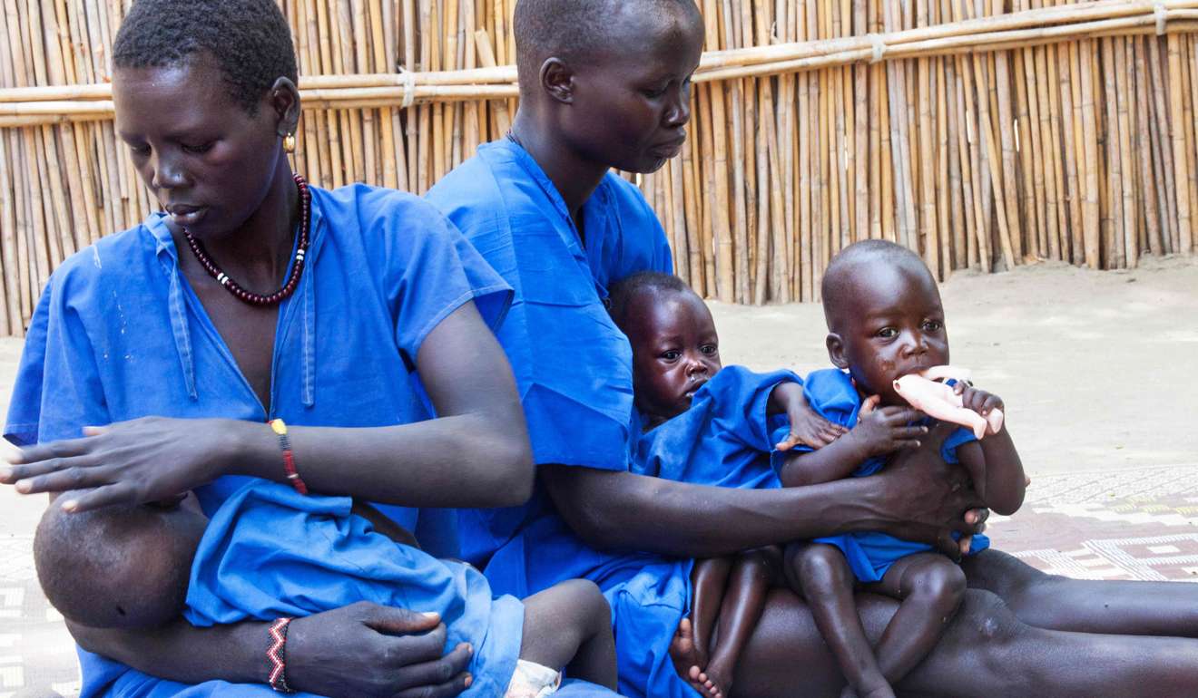 Women comfort their acutely malnourished children at a stabilisation centre in Ganyiel, South Sudan, on March 4. Photo: AFP