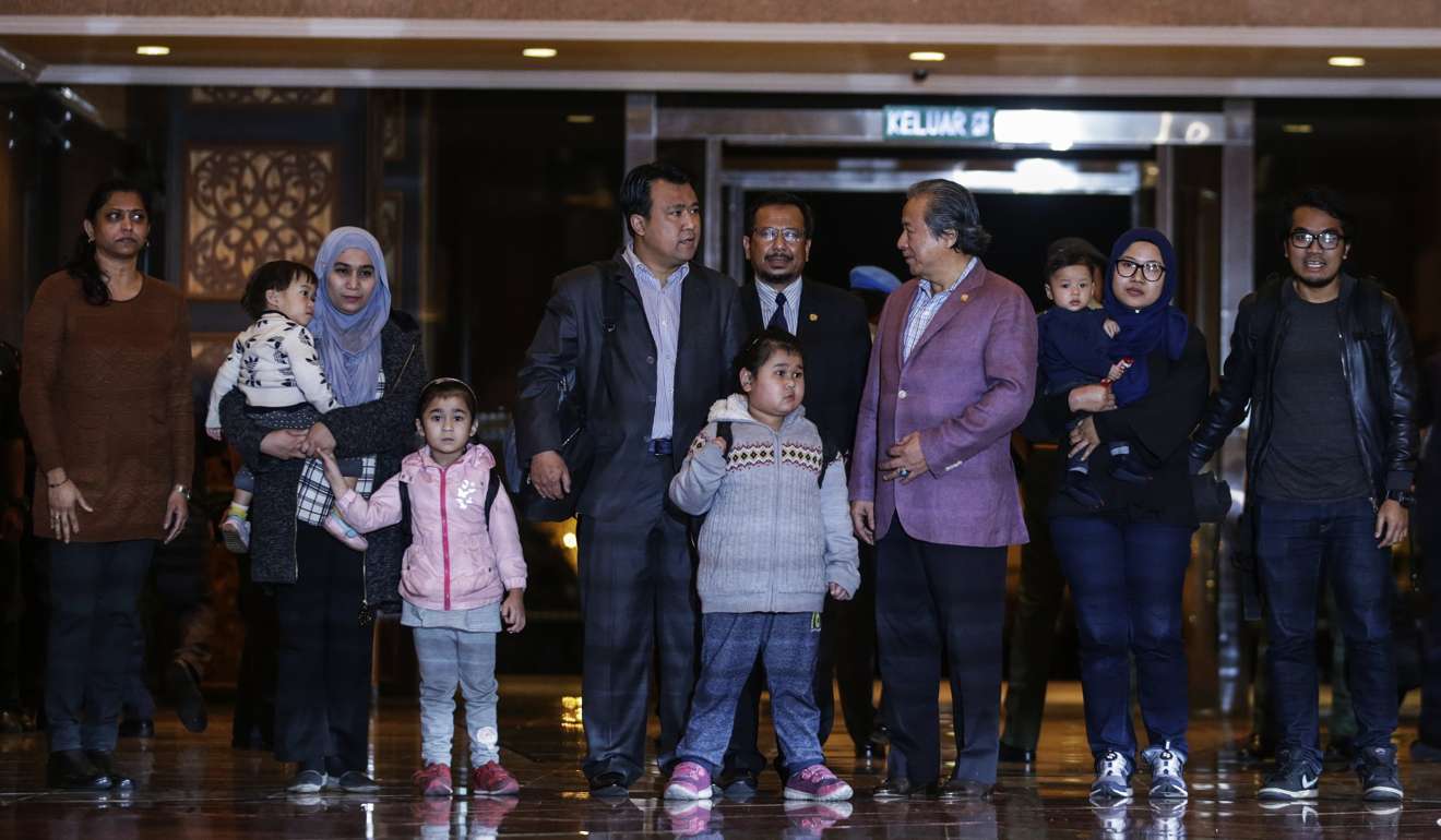 Malaysia's Foreign Minister Anifah Aman (fourth from right) walks with nine Malaysian citizens freed from North Korea after they arriving at Kuala Lumpur International airport in Sepang on Friday. Photo: EPA