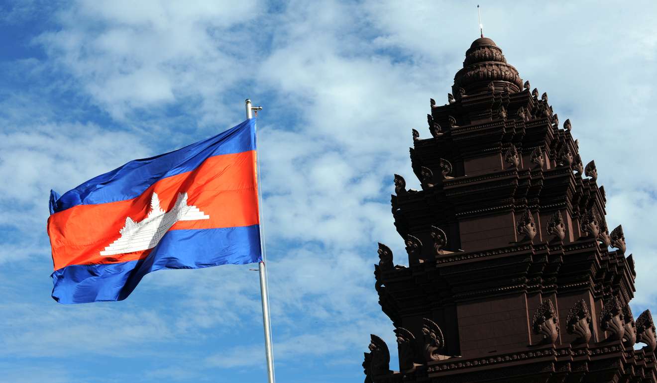 A Cambodian flag waves at the Independent Monument in Phnom Penh. Cambodia has long been a kind of second home for colourful characters. Photo: AFP