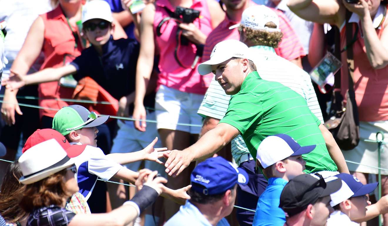 Jordan Spieth shakes hands with fans as he leaves the 18th hole during a practice round prior to Masters. Photo: AFP
