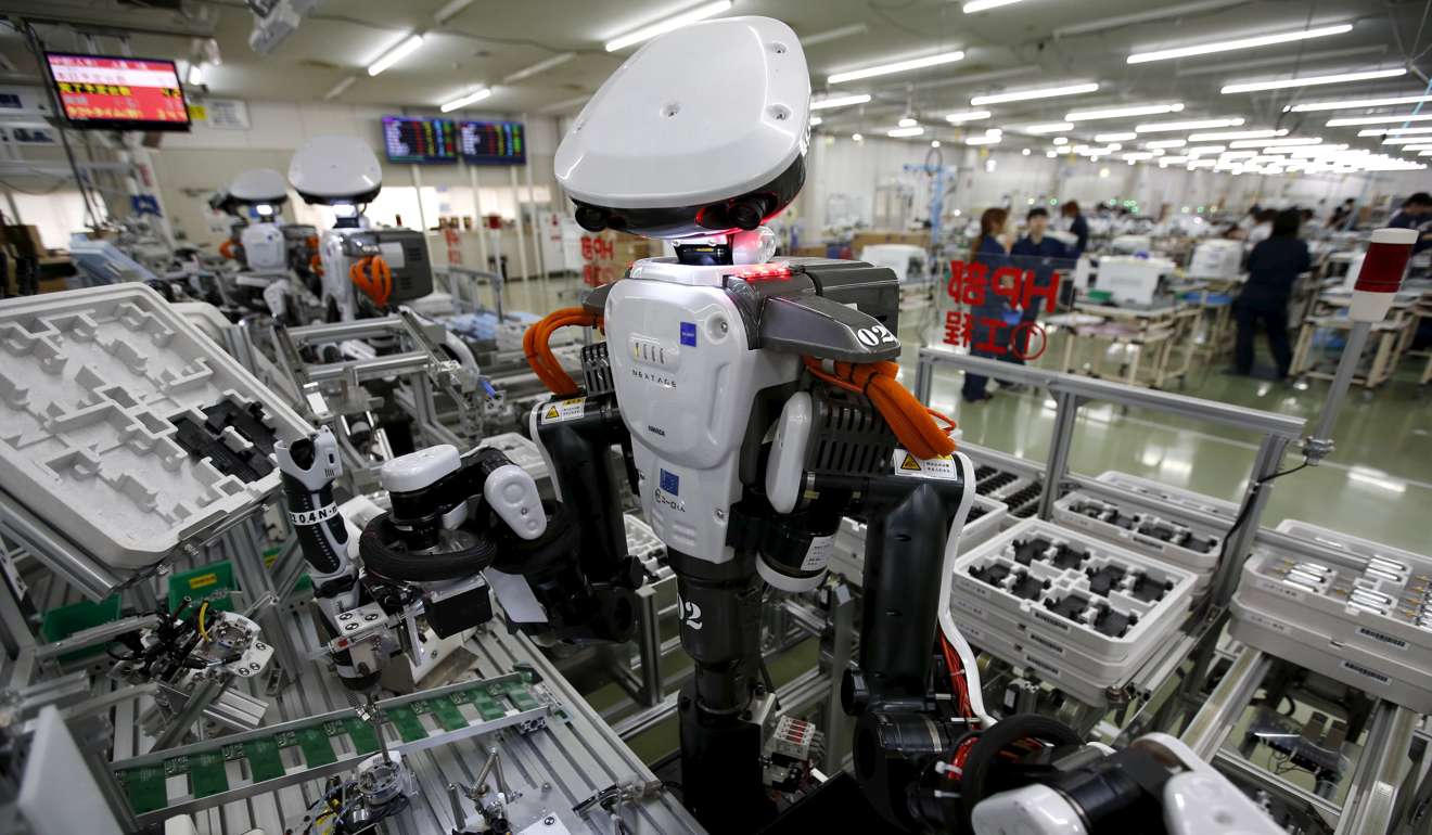 Humanoid robots on the assembly line of a factory making automatic change dispensers in Kazo, north of Tokyo. Photo: Reuters