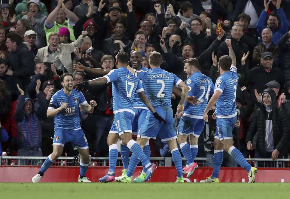 Bournemouth players celebrate after King’s equaliser. Photo: AP