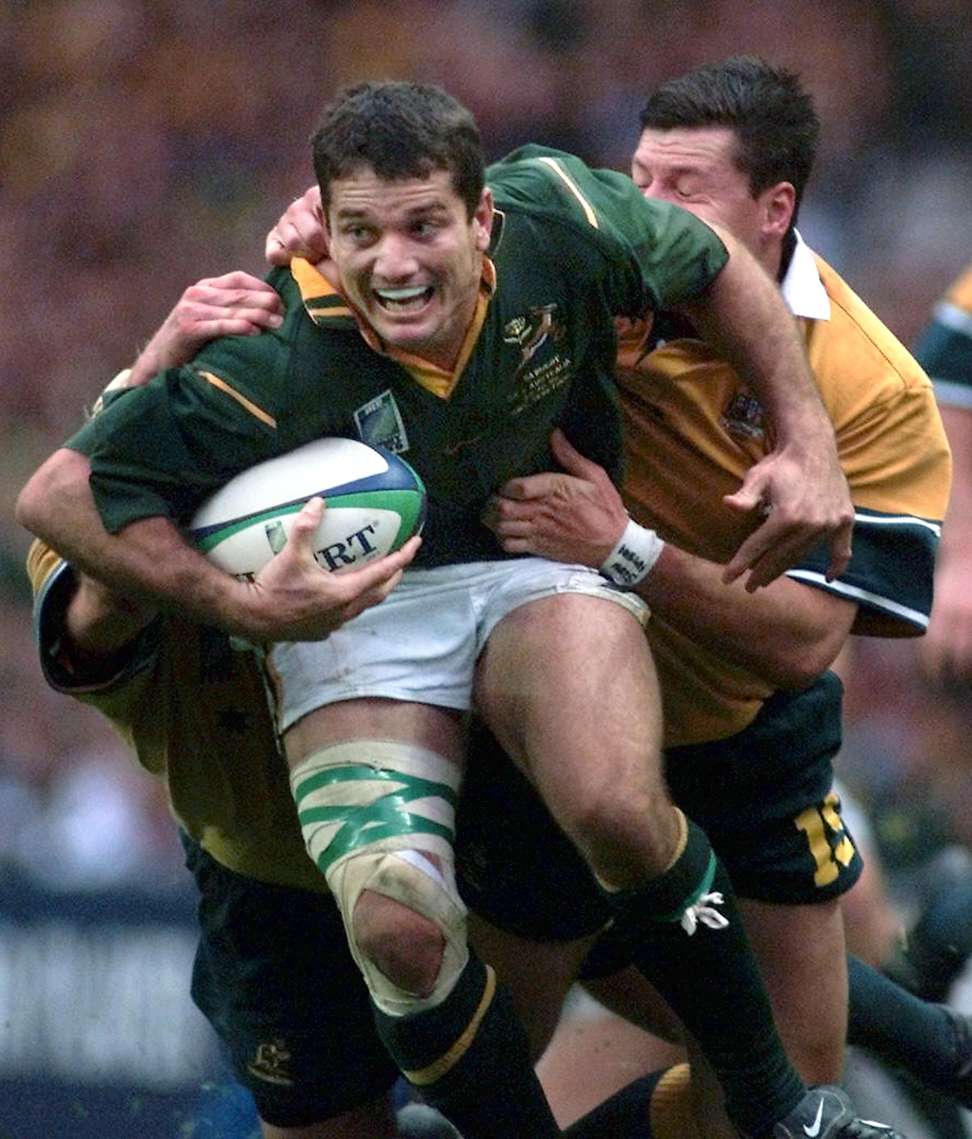 Joost Van Der Westhuizen is tackled by Australia’s Matthew Burke during the 1999 Rugby World Cup. Photo: AFP