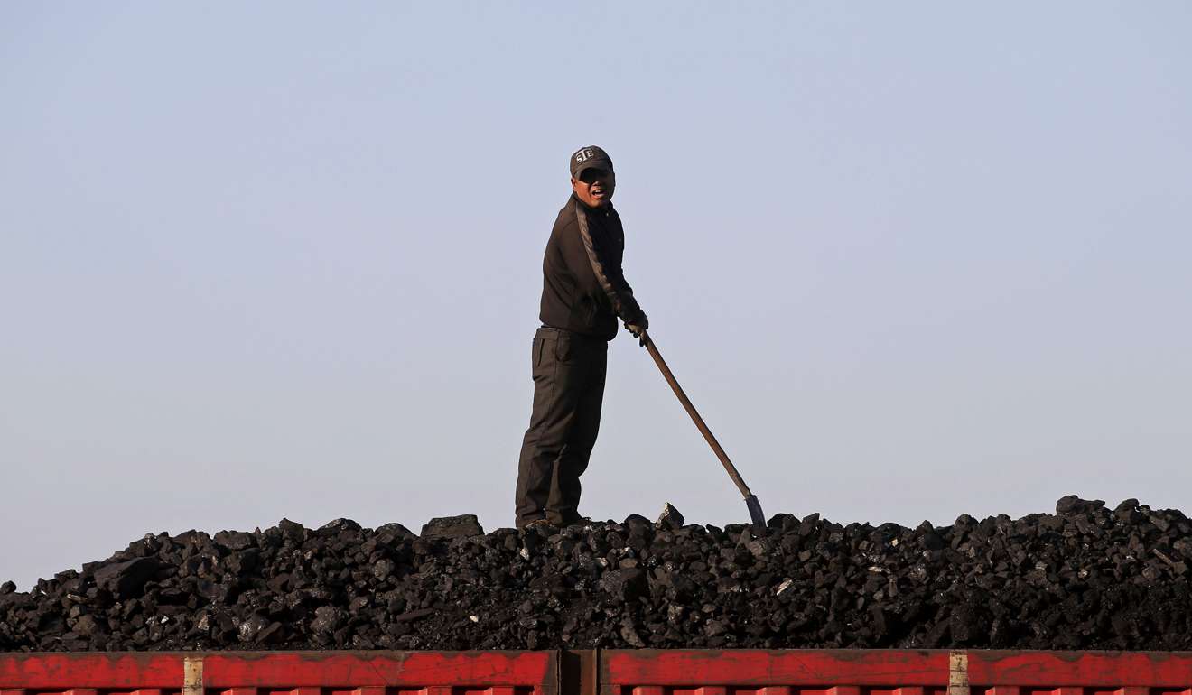 A worker loads coal on a truck at a depot near a coal mine from the state-owned Longmay Group on the outskirts of Jixi, in Heilongjiang province, China. Increasingly, investment is moving away from industrial companies and into housing. Photo: Reuters