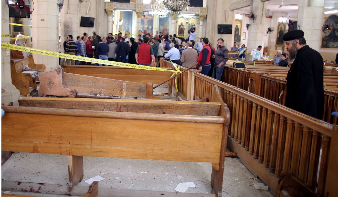A coptic priest looks on at the damages as security personnel investigate the scene of a bomb explosion inside Mar Girgis church in Tanta. Photo: EPA
