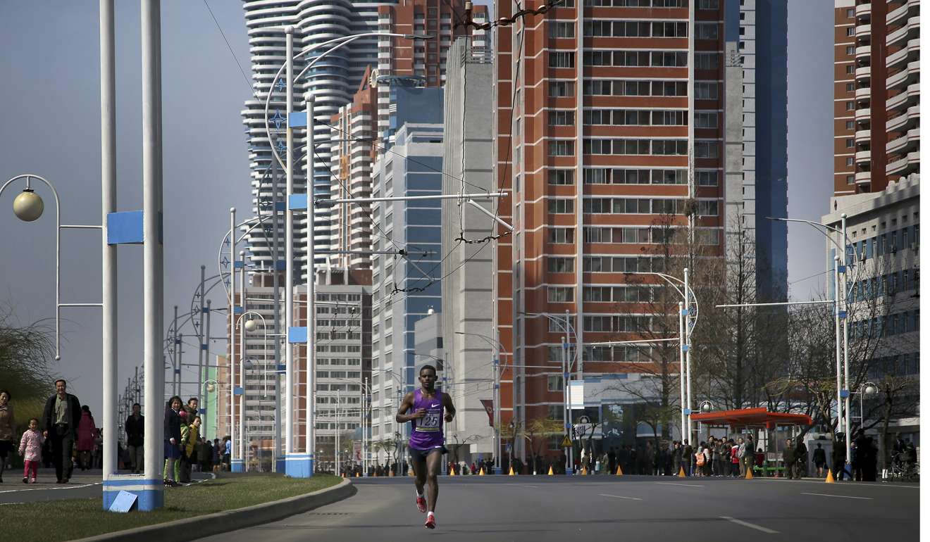 A participant of the Pyongyang marathon runs down Mirae Scientist Street. Photo: AP