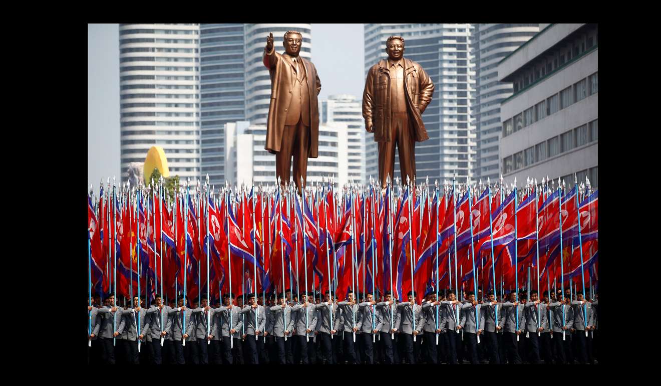 Celebrating in front of statues of North Korea founder Kim Il-sung (left) and late leader Kim Jong-il on Saturday. Photo: Reuters