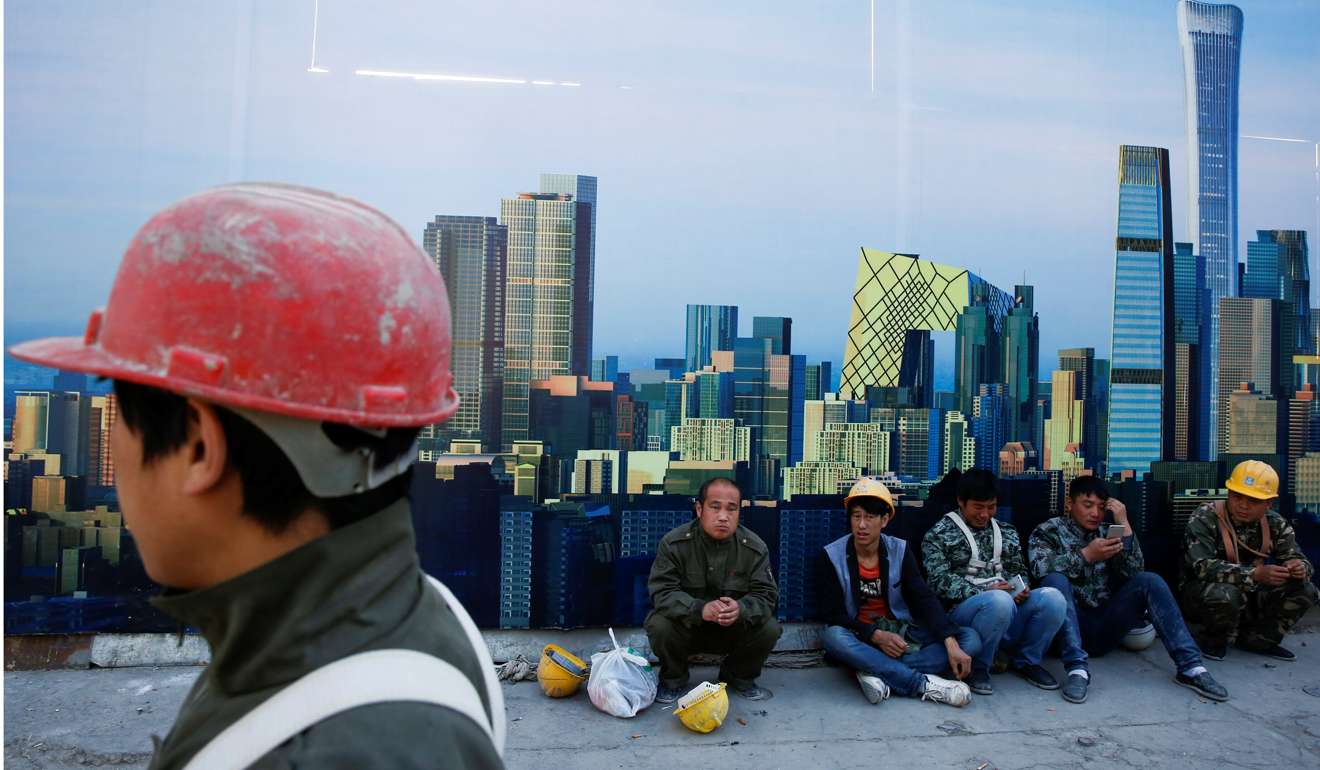 Workers sit outside a construction site in the Central Business District in Beijing. The 9.1 per cent year-on-year growth in property investment has made a significant contribution to the uptick in growth. Photo: Reuters
