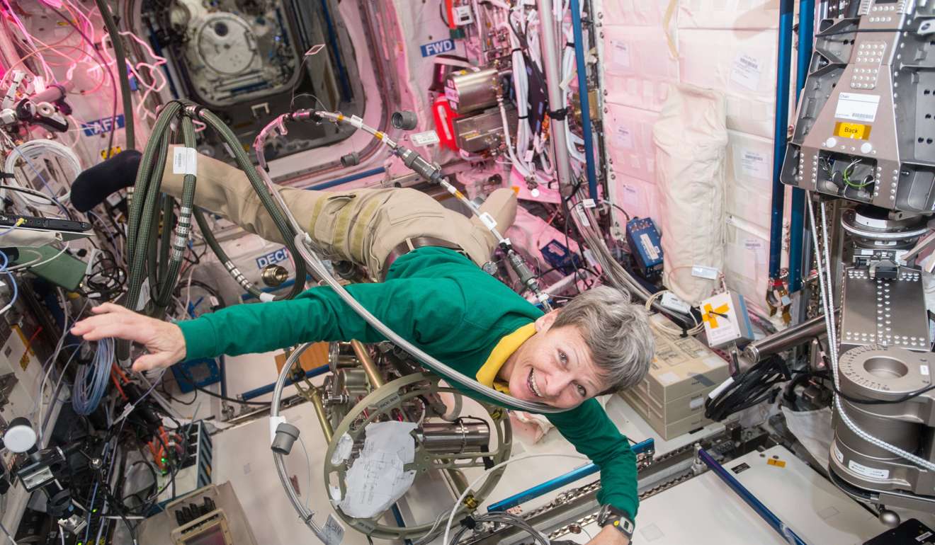 A handout photo made available by NASA's Johnson Space Centre shows astronaut Peggy Whitson floating through a tangle of cables inside the Columbus module aboard the International Space Station (ISS). Photo: NADA Handout via EPA