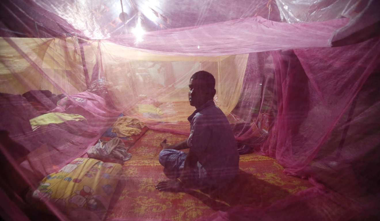 A Rohingya Muslim migrant sits inside a mosquito net at a refugee camp in Aceh, Indonesia, in June 2015. Photo: EPA