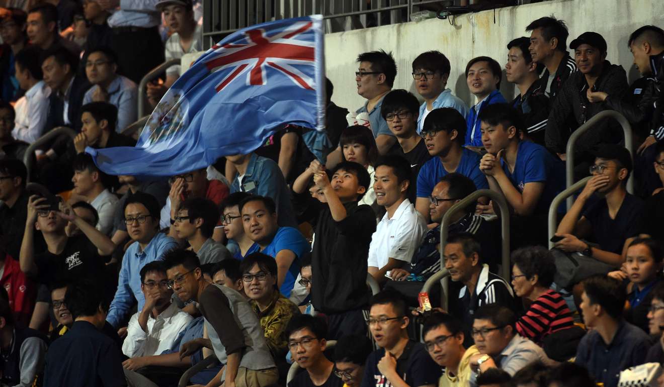 An Eastern fan waves the old British colonial flag of Hong Kong at Mong Kok Stadium.