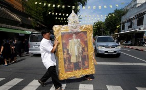 A man carrying a portrait of King Bhumibol Adulyadej. Photo: Reuters