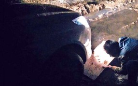 The stranded driver uses a conventional road map after his phone’s GPS route left his car stuck in a muddy ditch. Photo: SCMP Pictures The stranded driver uses a conventional road map after his phone’s GPS route left his car stuck in a muddy ditch. Photo: SCMP Pictures