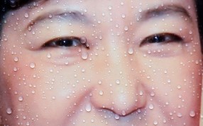 Rain drops are seen on a poster of Park Geun-hye. A corruption scandal has sent Park Geun-hye’s approval ratings diving to five per cent, a record low for a South Korean president. Photo: Reuters
