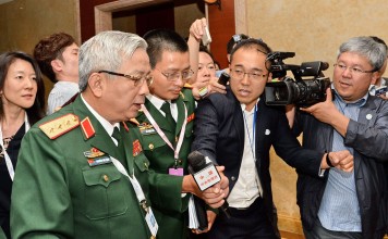 Vietnam's Deputy Defence Minister Nguyen Chi Vinh is surrounded by the media after a meeting Chinese officials on the sidelines of the Shangri-La Dialogue in Singapore on Friday. Photo: AFP