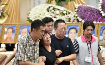 Relatives of 24 mainland tourists who died in Tuesday’s bus fire in Taiwan mourn at Chungli the funeral parlour in Taoyuan, northern Taiwan on Thursday. Photo: AFP July 21, 2016. Distraught relatives of 24 Chinese tourists who died after a fire ripped through their bus in Taiwan broke down in tears on July 21 as they arrived on the island to identify their loved ones. / AFP PHOTO / SAM YEH