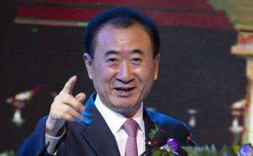 Wanda Group chairman Wang Jianlin gestures as he speaks during a signing ceremony in Beijing on June 16, 2016. Photo: AP