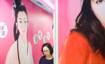 A woman browses books at the annual Hong Kong book fair in Wan Chai. Photo: AFP