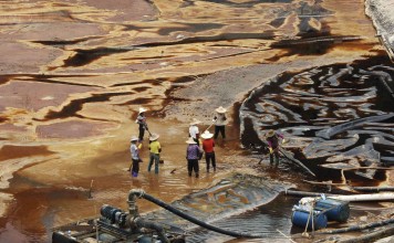 Labourers work to drain sewage water from a leaked sewage tank at a copper mine in Shanghang, Fujian province. China’s mining industry is notorious for its environmental damage, and the pollution is usually irreversible. Photo: Reuters