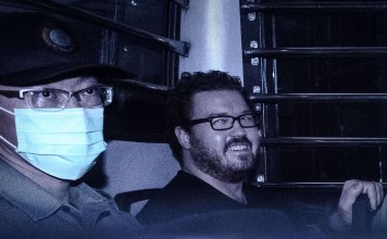 British banker Rurik Jutting smiles as he leaves court in Hong Kong. Photo: AFP