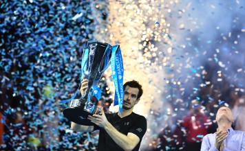Britain's Andy Murray celebrate with the trophy after winning the men's singles final against Serbia's Novak Djokovic on the eighth and final day of the ATP World Tour Finals tennis tournament in London on November 20, 2016. / AFP PHOTO / Glyn KIRK