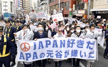Chinese residents in Japan march at a protest against the Japanese hotel chain APA in Tokyo. Photo: Kyodo