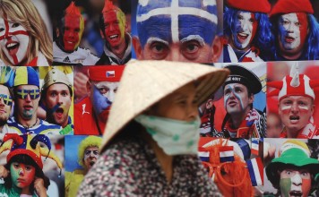 A cyclist in Hanoi rides past an advert for a European football tournament. Illegal gambling, such as on football competitions, is popular in Vietnam. Photo: AFP