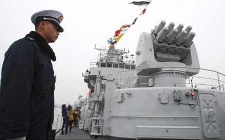 A member of China's People Liberation Army (PLA) stands at guard on the missile destroyer 'Qingdao'. Photo: EPA A member of China's People Liberation Army (PLA) stands at guard on the missile destroyer 'Qingdao'. Photo: EPA
