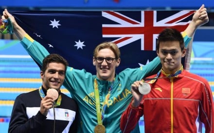 Gold medal winner Mack Horton of Australia (centre) poses for photographers with silver winner Sun Yang of China (right) and bronze winner Gabriele Detti of Italy after the men’s 400m freestyle final on Saturday. Photos: EPA