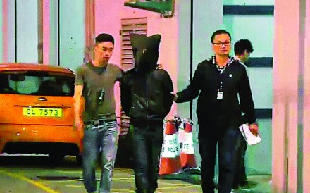 One of the five suspects is was escorted to Tsuen Wan police station at about 1am on Thursday. Photo: SCMP Pictures