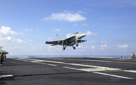 An FA-18 jet fighter lands on the USS John C. Stennis aircraft carrier in the South China Sea. Photo: AP