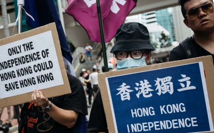 Protesters hold placards calling for Hong Kong’s independence during a rally on July 1. Photo: Bloomberg