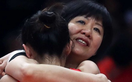 Coach Lang Ping hugs Ding Xia after China beat Serbia in the gold medal match. Photo: Reuters