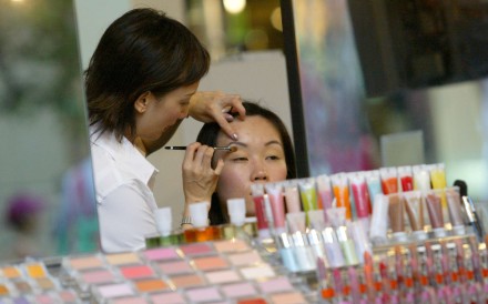 A customer gets a makeover at a cosmetics counter in Causeway Bay. Photo: David Wong