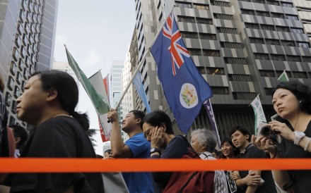 Protesters raise a Hong Kong colonial flag as thousands of people rally earlier this month against the latest NPC interpretation of the Basic Law. Photo: AP Protesters raise a Hong Kong colonial flag as thousands of people rally earlier this month against the latest NPC interpretation of the Basic Law. Photo: AP