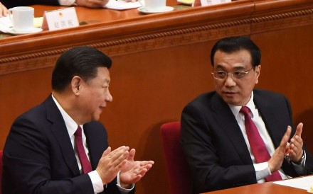 China's President Xi Jinping (L) and Premier Li Keqiang chat during the closing session of the National People's Congress, China's legislature, in Beijing's Great Hall of the People on March 15, 2017. Photo: AFP