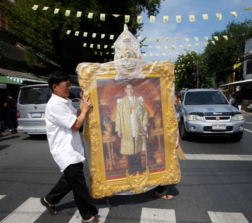 A man carrying a portrait of King Bhumibol Adulyadej. Photo: Reuters